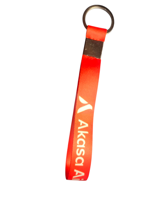 Red Akasa Air satin keychain with metal ring on white background